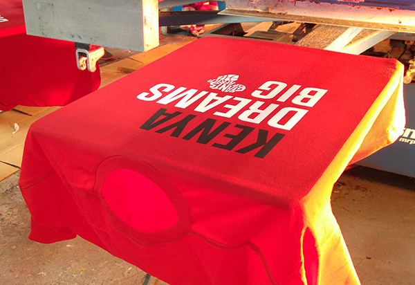 Entripy printing red customized t-shirts for TIFF screening documentary of Giants of Africa.