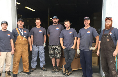 Employees wearing construct company custom t-shirt with their company logo.