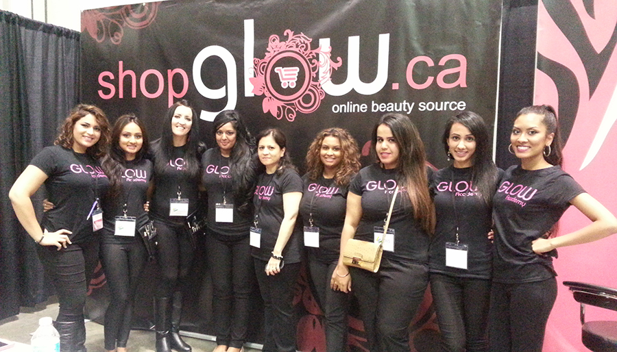Employees at Glow Academy wearing black custom t-shirts with their company logo.