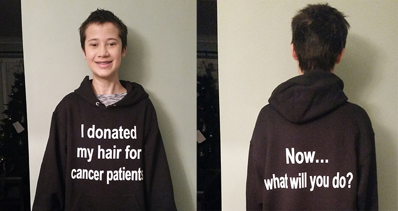 Kaitlyn Johnston wearing a black custom hooded sweatshirt to let others know her hair was donated for cancer.