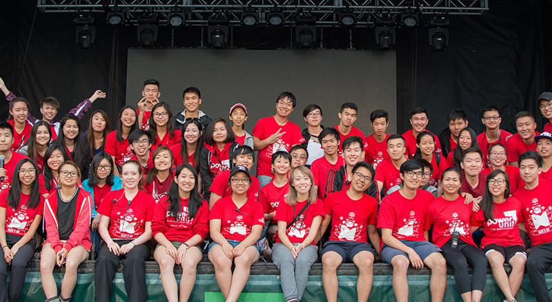 Youth at a charity event wearing red customized t-shirts with custom design.
