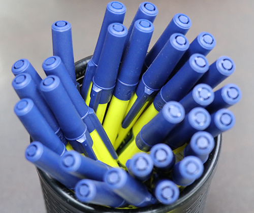 A pack of custom pens made with entripy logo and blue and yellow colours for clients.