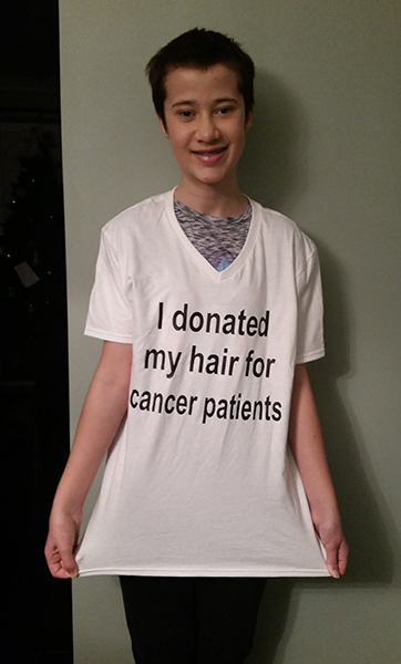 Kaitlyn johnston wearing a white custom t-shirt to bring awareness donating hair for cancer