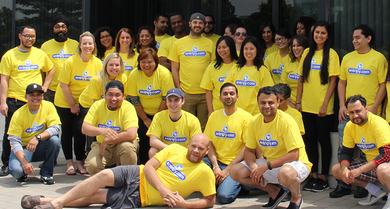 Entripy employees branded in yellow custom t-shirts with entripy logo.