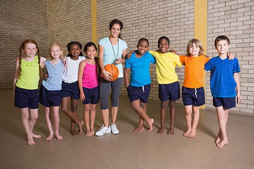 Kids basketball team wearing colourful custom t-shirts.