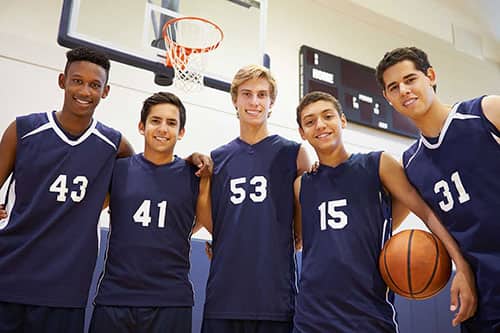 Sports basketball team wearing customized jerseys with personalized numbers.