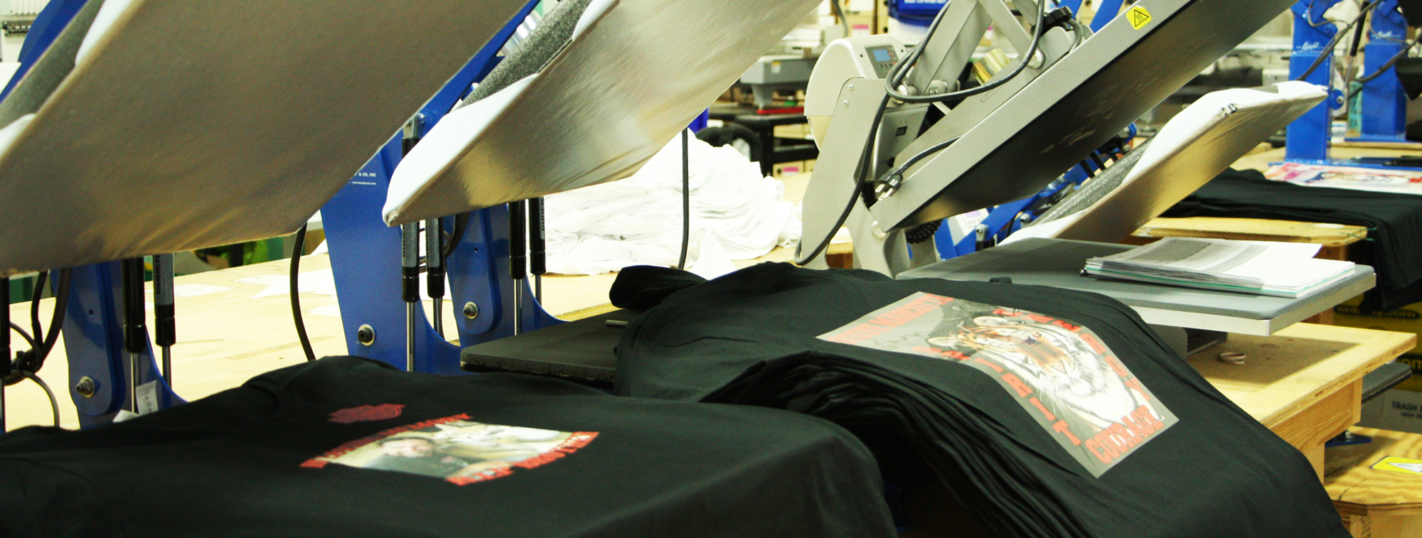 Savvy prints digital printing press heat pressing custom logos for client orders.