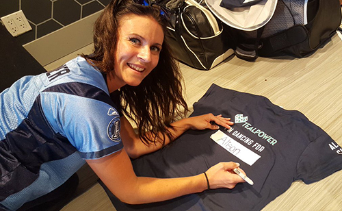 Argos cheerleader wearing custom jersey and custom t-shirt to raise money for cervical cancer.