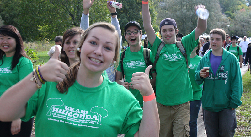 Participants in a summer camp wearing green custom t-shirts with their customized design.