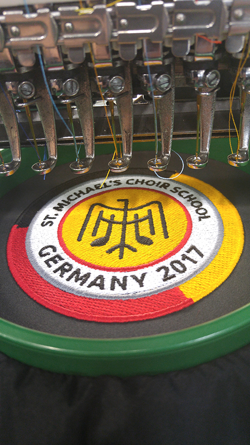 School custom logo getting embroidered with various colours and images.