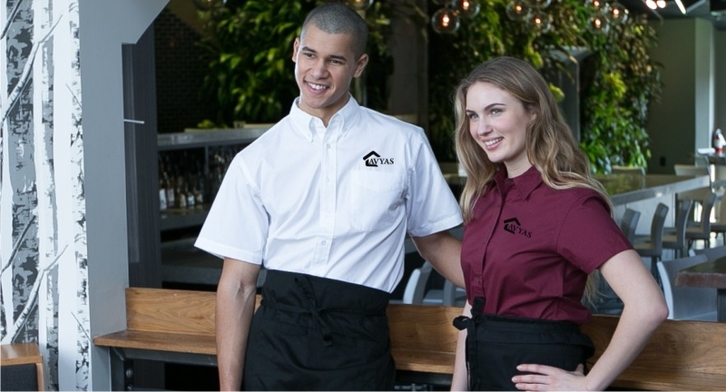 Man and women wearing restaurant themed apparel.