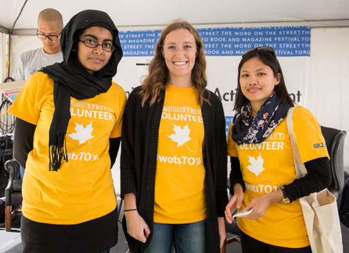 Volunteers wearing yellow custom t-shirts to bring awareness to a charity organization.