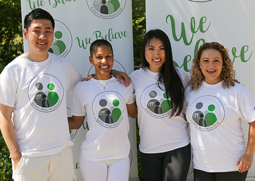 Yoga participants wearing Demarre Carroll's custom t-shirts showcasing healthy living slogan.