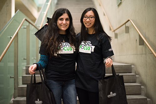 Frosh week students wearing custom school shirts with their team logo and holding custom tote bags.
