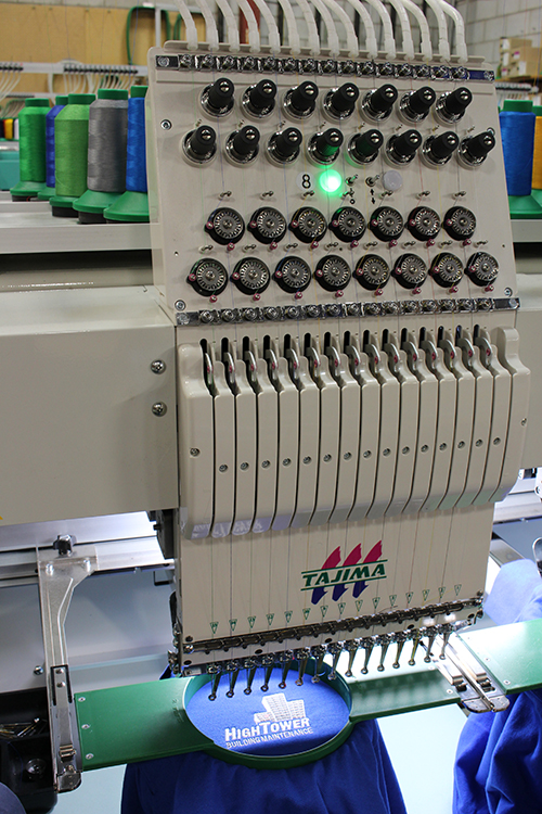 Showcasing the new features of the Tajima embroidery machine at Entripy for custom embroidered orders.