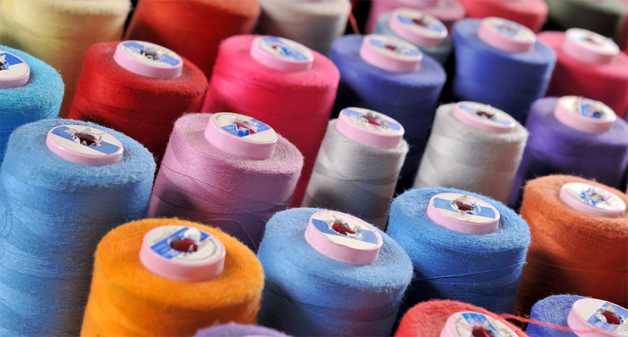 Selection of different colour threads that are used to embroider custom apparel.