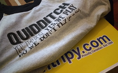 Colour contrast custom t-shirt showcasing a custom design with Entripy's yellow shipping box.