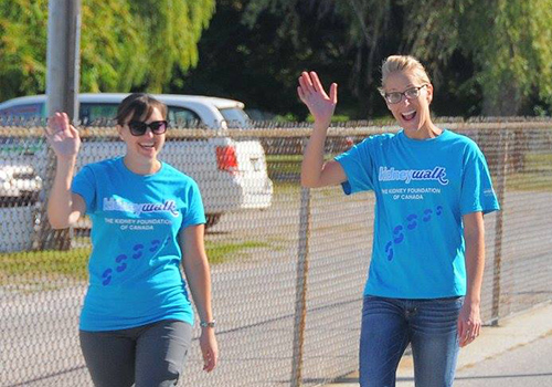 Kidney Walk participants walking at the fundraising event wearing blue customized t-shirts.