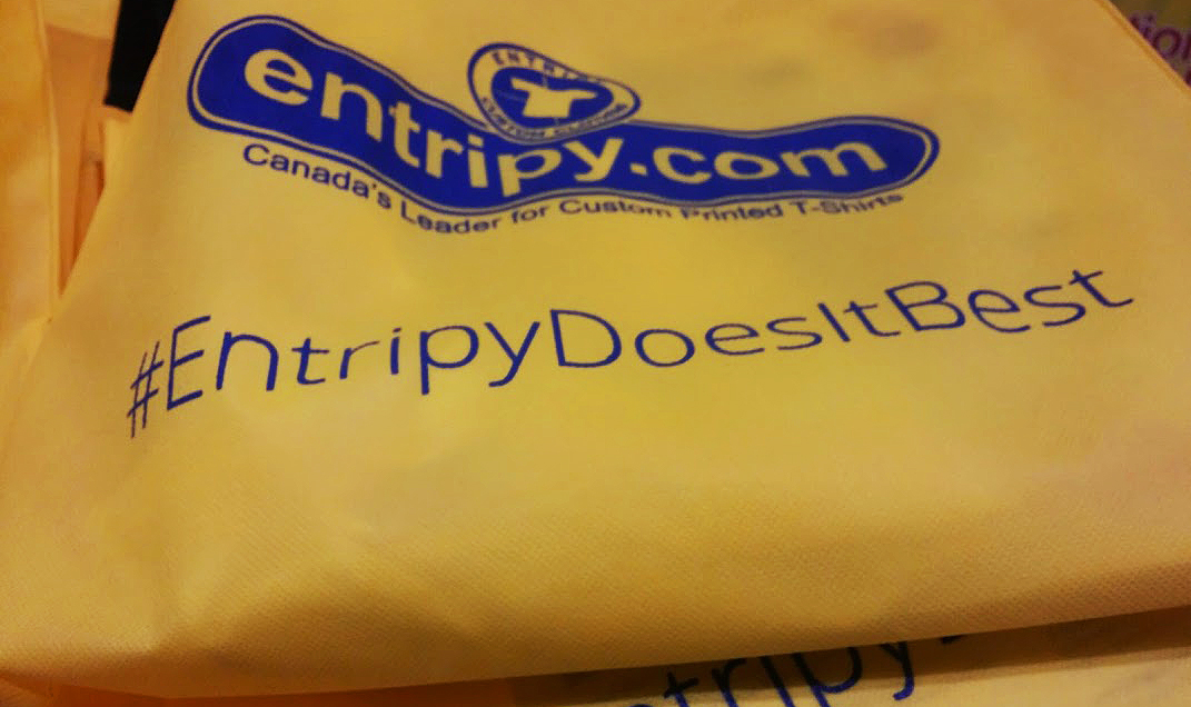 Bright yellow printed custom tote bag with with entripy logo for giveaways.