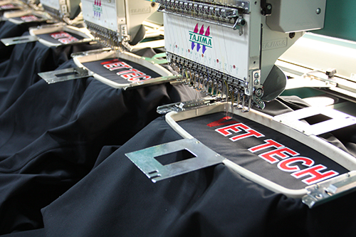 Embroidering custom jackets for Entripy's client order.