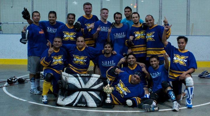Group of hockey players showcasing custom printed jerseys for their hockey team.