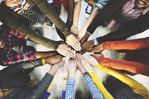 Diverse companies working together and building their network in custom apparel industries.