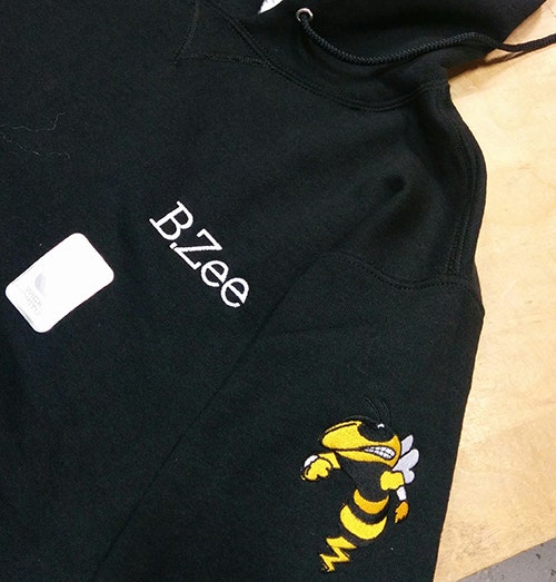 Custom sweatshirt embroidered with logo for client order.